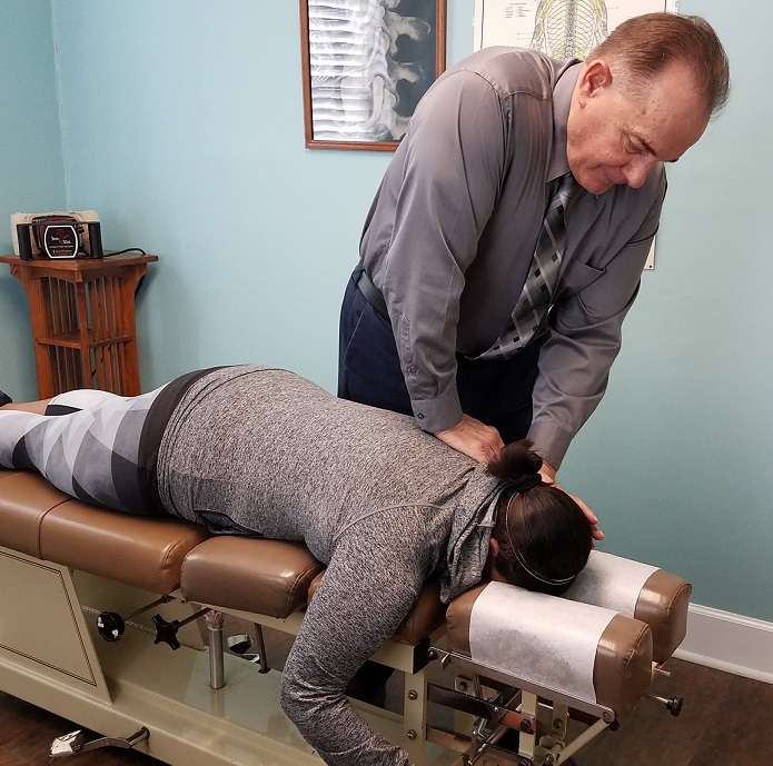 Doctor adjusting spine